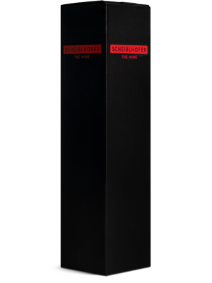 Tall black wine box with red label with the inscription Scheiblhofer The Wine on a plain background.