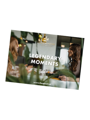 Two women smile and chat at a table with text: Legendary moments and a resort website.