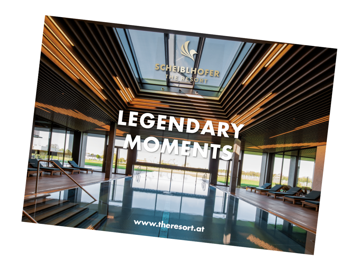 Moderne Resort-Lobby mit großen Fenstern, hölzernem Interieur und dem Text Legendary Moments an prominenter Stelle.
