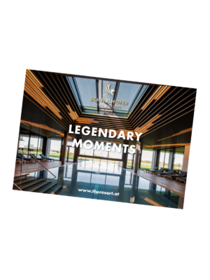 Modern resort lobby with large windows, wooden interior and the text Legendary Moments in a prominent position.